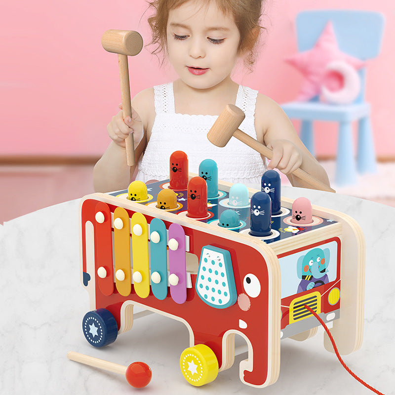 Child exploring musical hammer bus