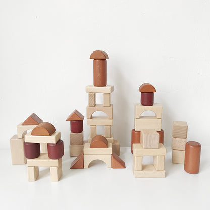 Natural colored wooden stacking blocks assembled into creative buildings
