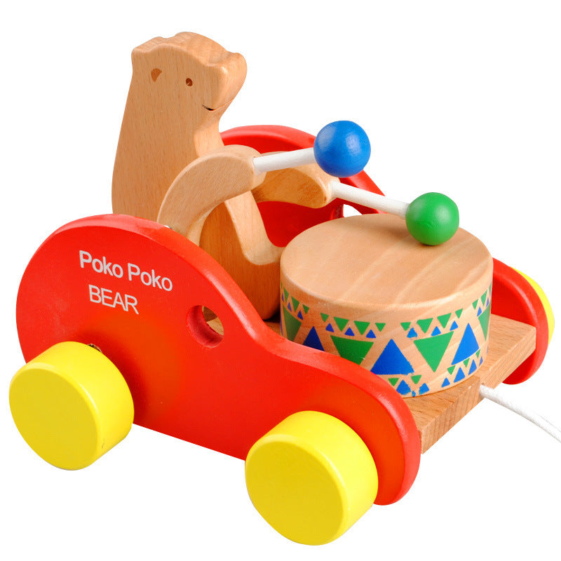 Red wooden bear pull-along drumming toy with yellow wheels and blue green drum mallets